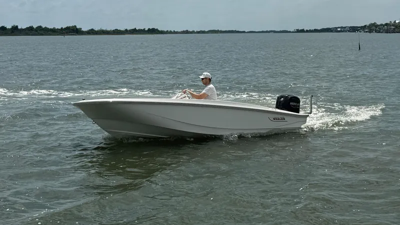 Slide: The Image of 2023 Boston Whaler 160 Super Sport cruising on a calm lake. - 10