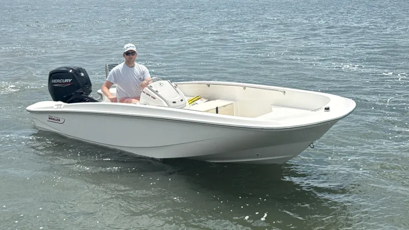 Slide: The Image of 2023 Boston Whaler 160 Super Sport boat on water with Mercury engine. - 11