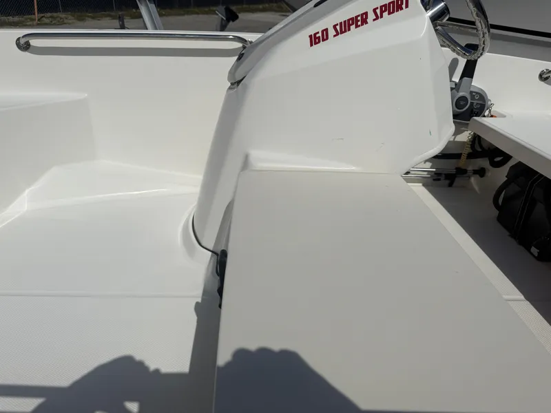 Slide: The Image of 2023 Boston Whaler 160 Super Sport interior with steering console and seating area. - 16