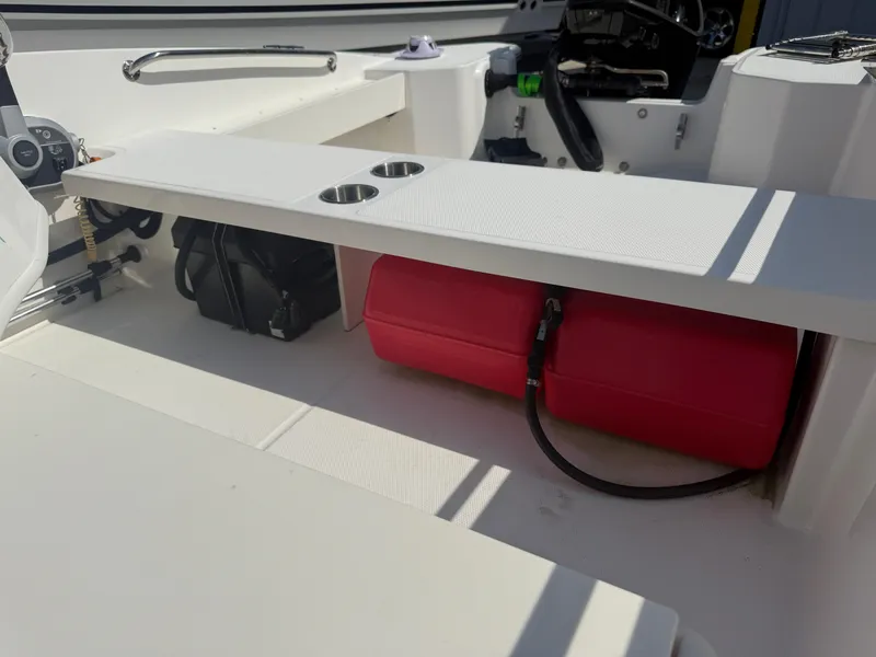 Slide: The Image of 2023 Boston Whaler 160 Super Sport interior with red fuel tank and storage area. - 17
