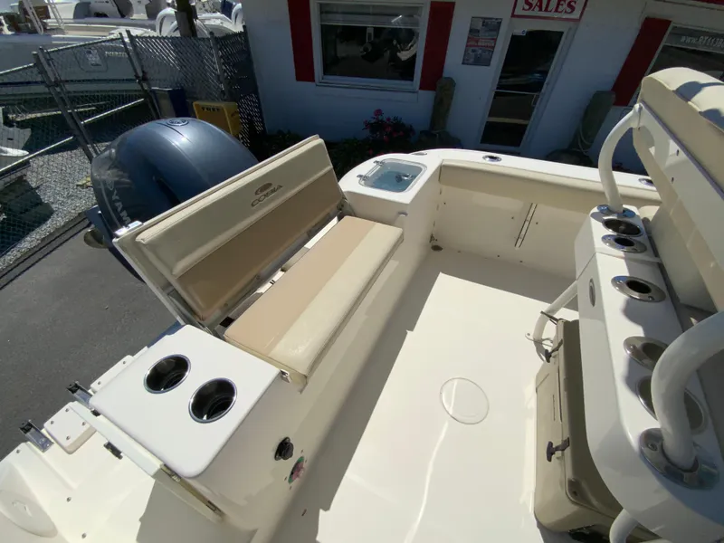 Slide: The Image of 2019 Cobia 220 Center Console boat interior with seating and cup holders. - 14