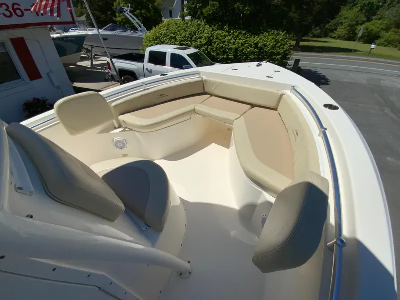 Slide: The Image of 2019 Cobia 220 Center Console boat with spacious seating and sleek design. - 20