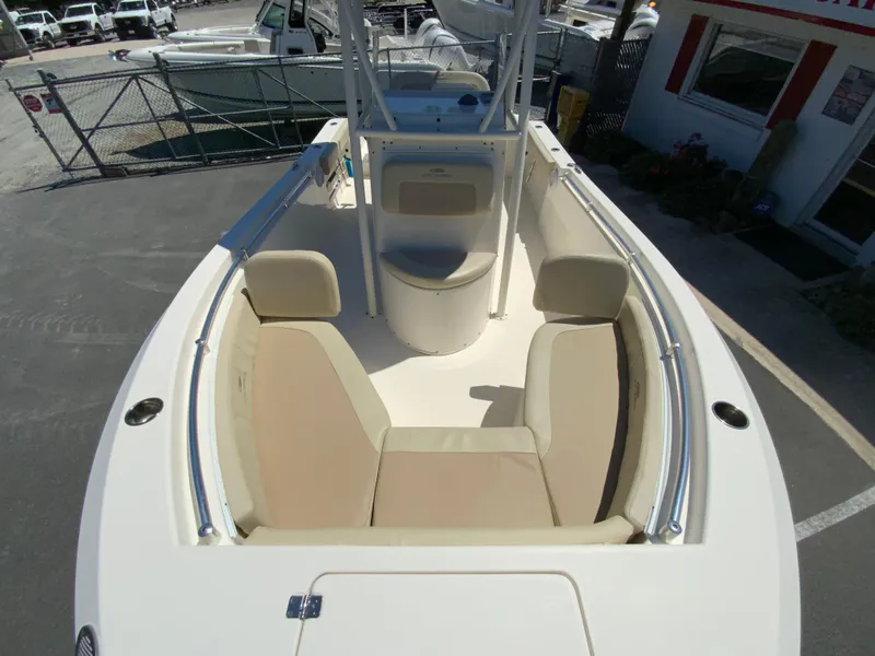Slide: The Image of 2019 Cobia 220 Center Console boat with beige seating and sleek design. - 22