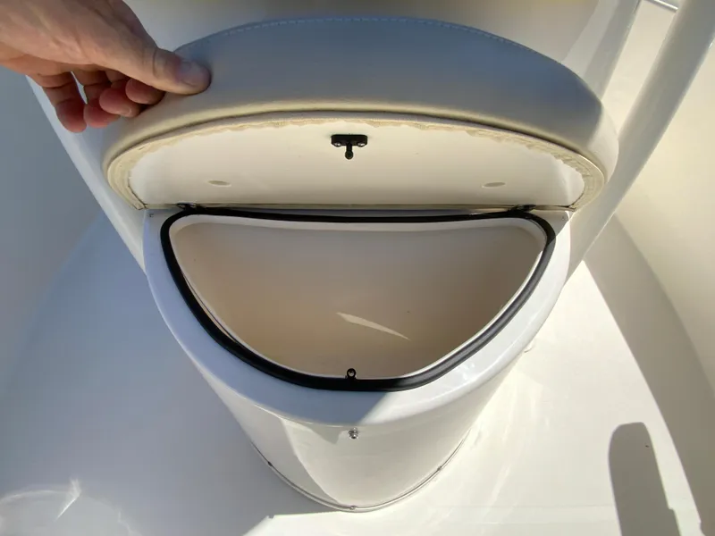 Slide: The Image of 2019 Cobia 220 Center Console storage compartment with open lid. - 24