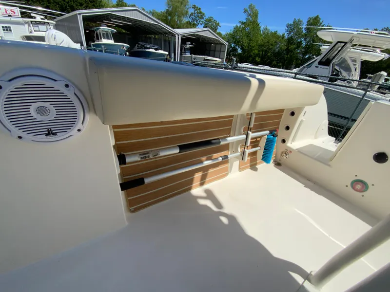 Slide: The Image of 2019 Cobia 220 Center Console boat interior with rod holders and speaker. - 26