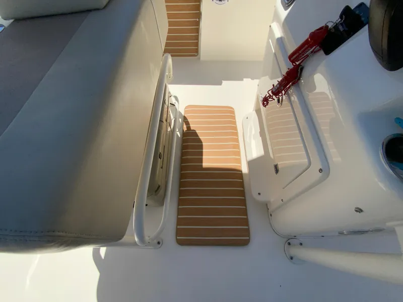 Slide: The Image of 2019 Cobia 220 Center Console interior with seating and deck details. - 28
