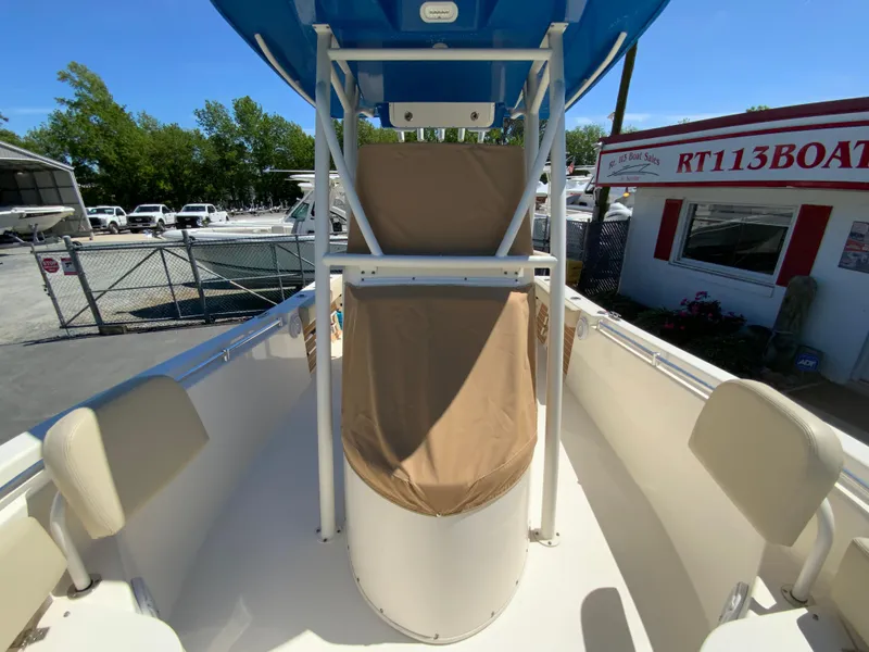 Slide: The Image of 2019 Cobia 220 Center Console boat with seating, docked at a marina. - 31