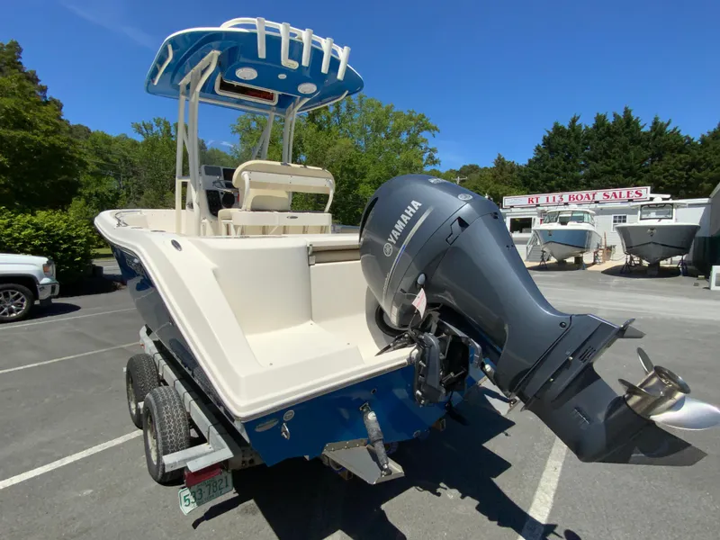Slide: The Image of 2019 Cobia 220 Center Console boat with Yamaha outboard motor on trailer. - 7