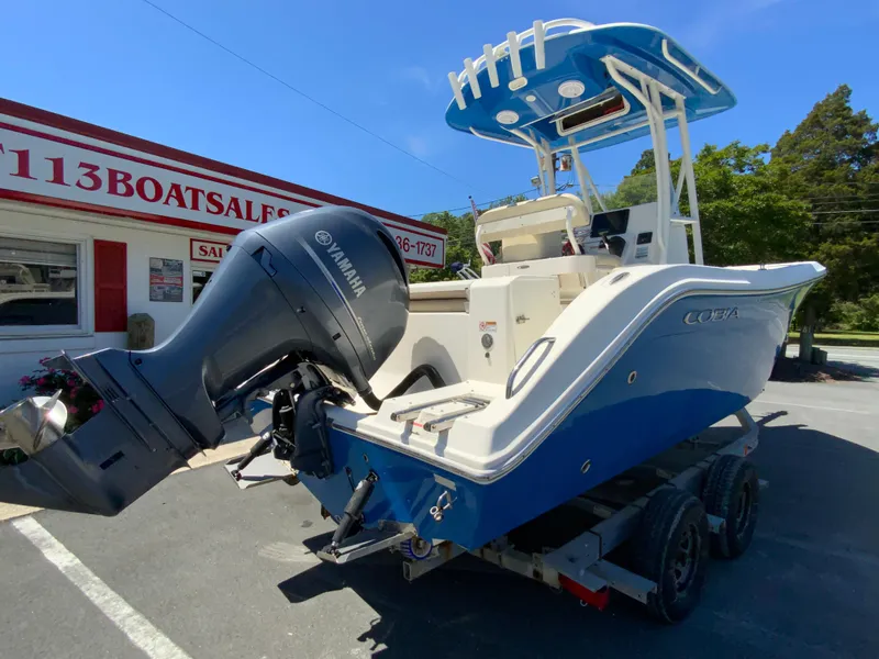 Slide: The Image of 2019 Cobia 220 Center Console boat with Yamaha engine on trailer at dealership. - 9
