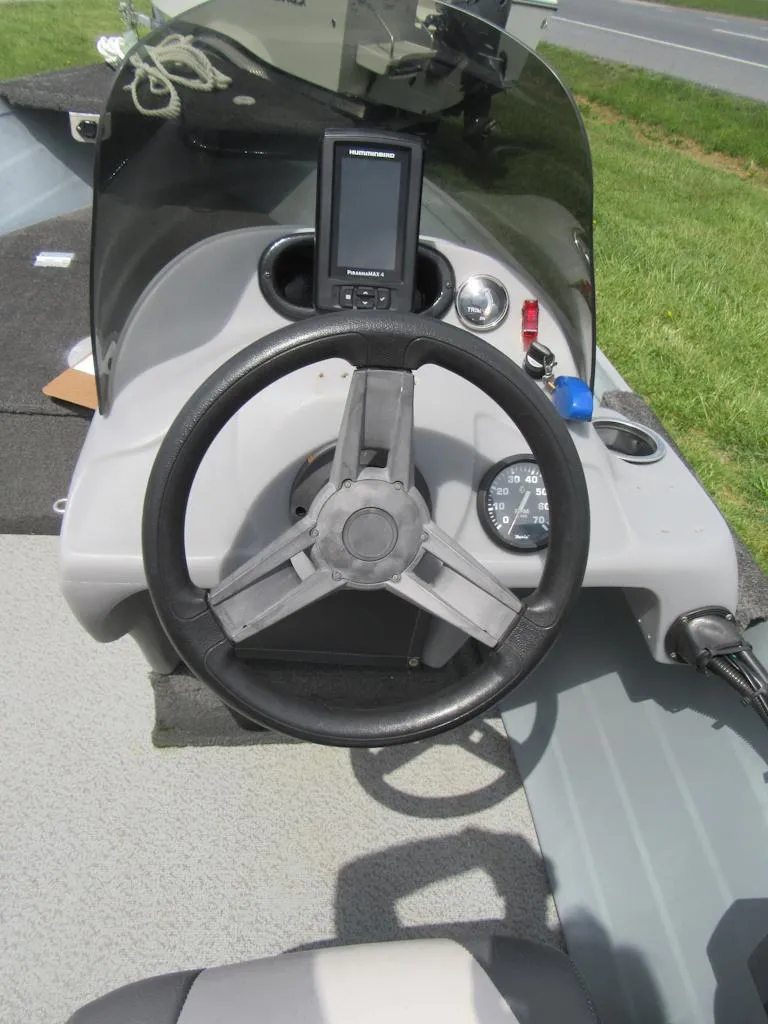 Slide: The Image of 2018 Starcraft SF DLX 16 boat dashboard with steering wheel and navigation system. - 10