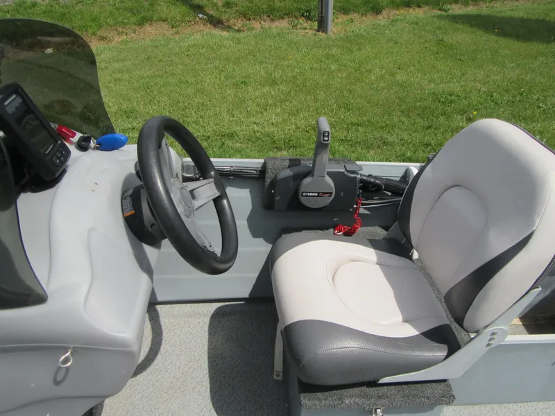Slide: The Image of 2018 Starcraft SF DLX 16 boat interior with steering wheel and seat. - 11