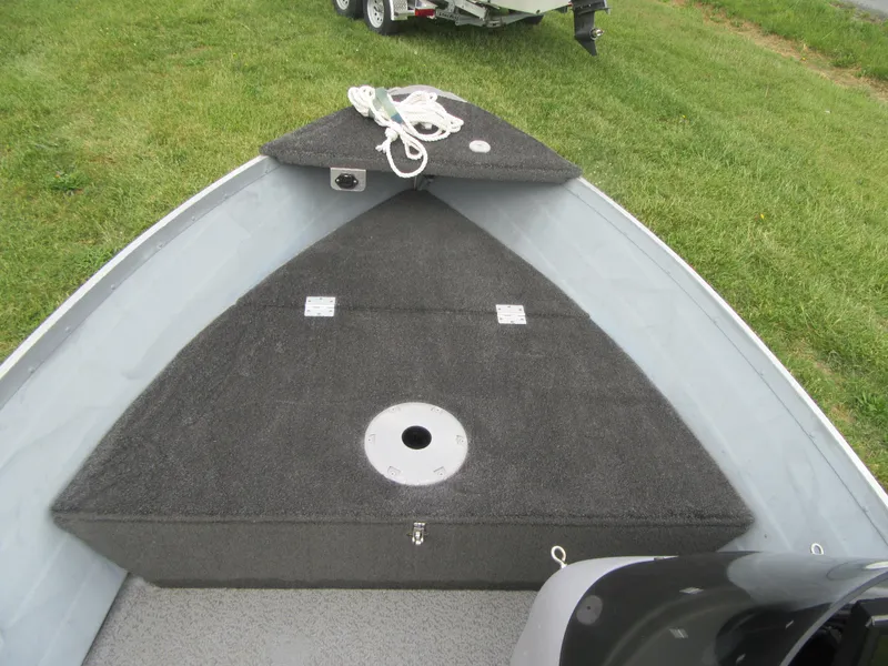 Slide: The Image of 2018 Starcraft SF DLX 16 boat interior with carpeted deck and storage compartments. - 12