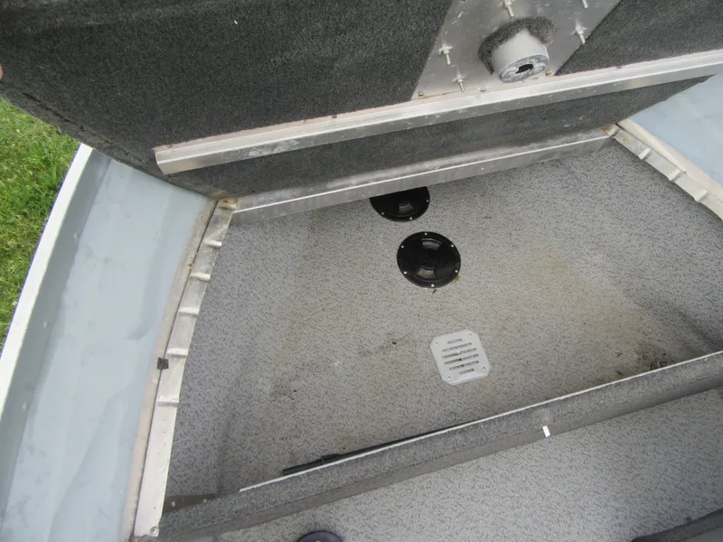Slide: The Image of 2018 Starcraft SF DLX 16 boat interior storage compartment with open hatch. - 15
