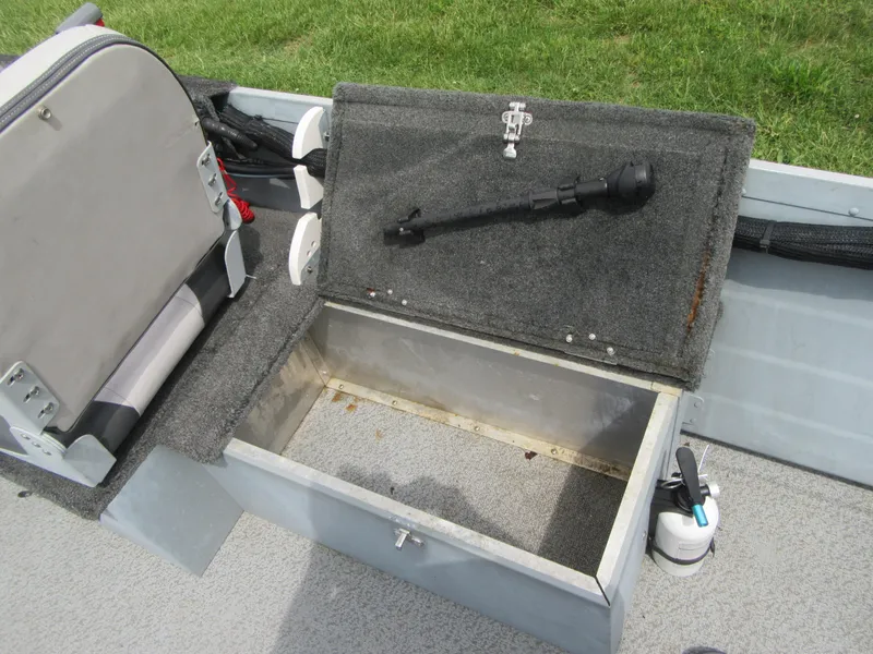 Slide: The Image of 2018 Starcraft SF DLX 16 boat storage compartment with open lid, revealing interior space. - 16