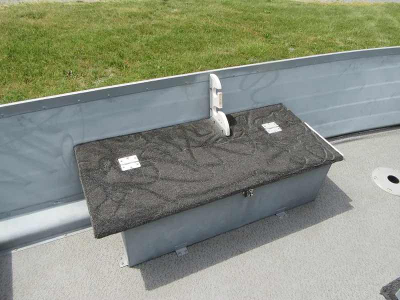 Slide: The Image of 2018 Starcraft SF DLX 16 boat interior with storage compartment and latch. - 17