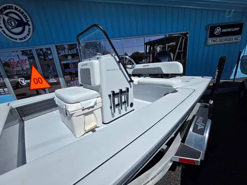 Slide: The Image of 2024 Hewes Redfisher 18 boat on trailer, displayed at a dealership. - 3