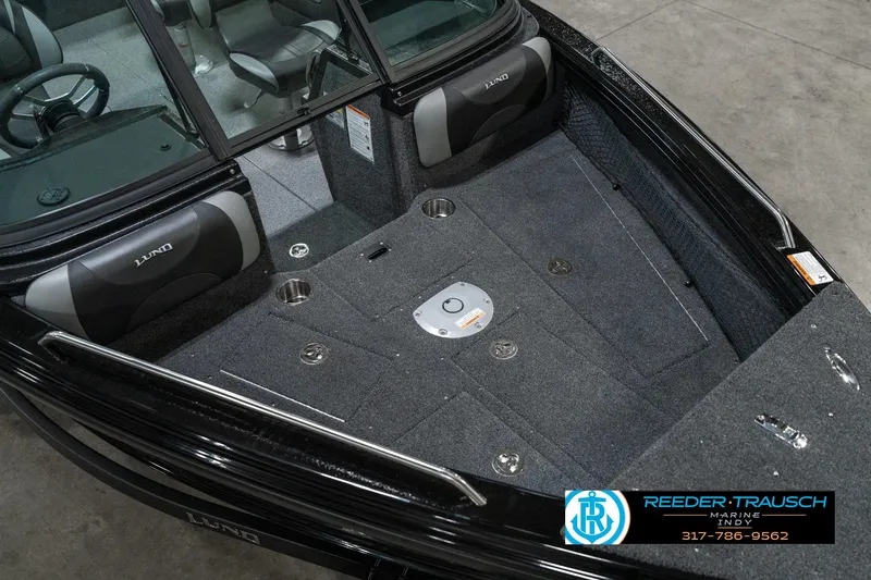 Slide: The Image of Interior of 2025 Lund 1975 Tyee boat with gray carpet and seating. - 12