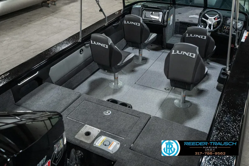 Slide: The Image of 2025 Lund 1975 Tyee boat interior with four seats and steering console. - 13