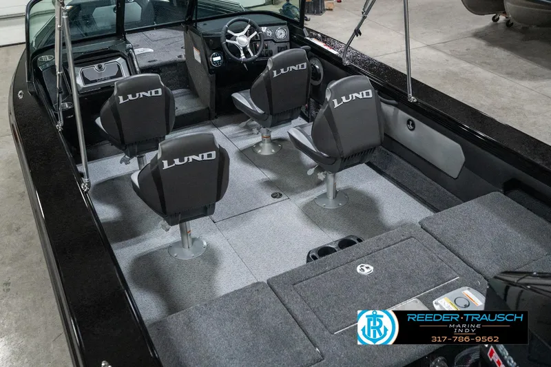 Slide: The Image of 2025 Lund 1975 Tyee boat interior with four seats and steering console. - 14