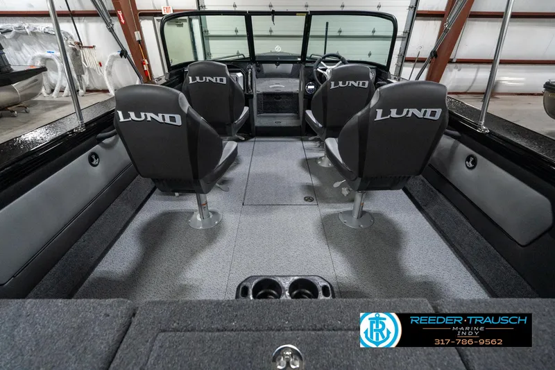 Slide: The Image of Interior of 2025 Lund 1975 Tyee boat with four seats in a showroom. - 15