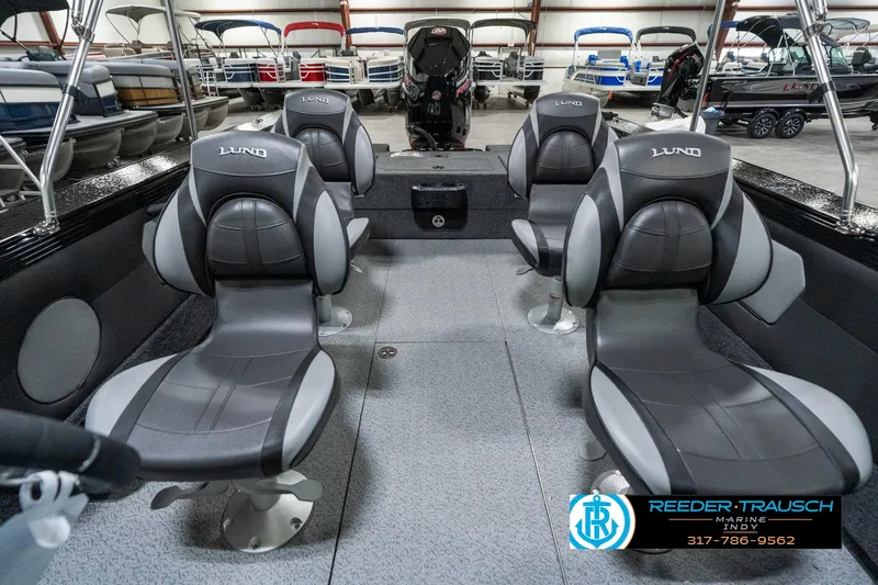 Slide: The Image of Interior of 2025 Lund 1975 Tyee boat with four gray seats in showroom. - 19