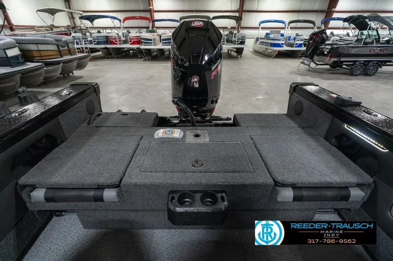 Slide: The Image of 2025 Lund 1975 Tyee boat interior with motor, displayed in a showroom. - 20