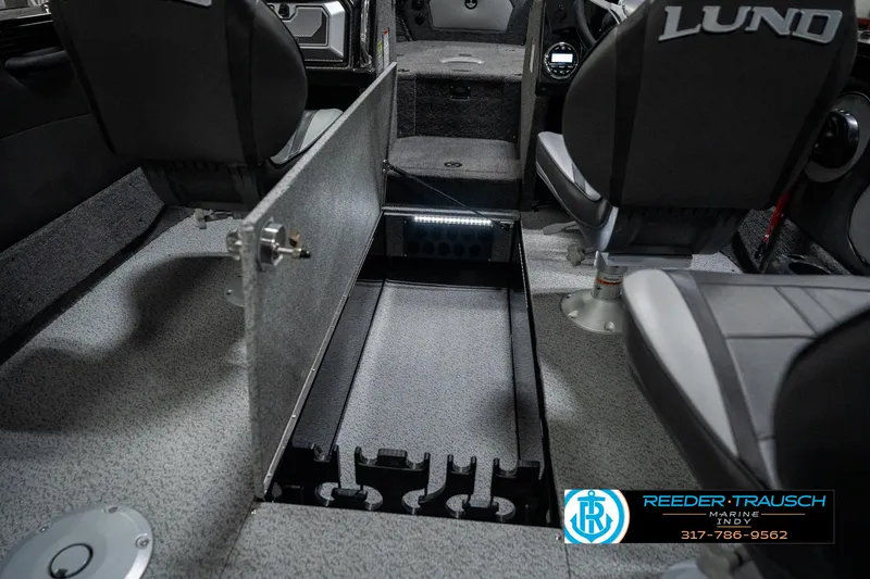 Slide: The Image of Interior of 2025 Lund 1975 Tyee boat with open storage compartment. - 30