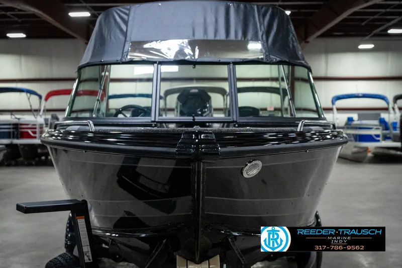 Slide: The Image of Front view of a 2025 Lund 1975 Tyee boat in a showroom. - 4