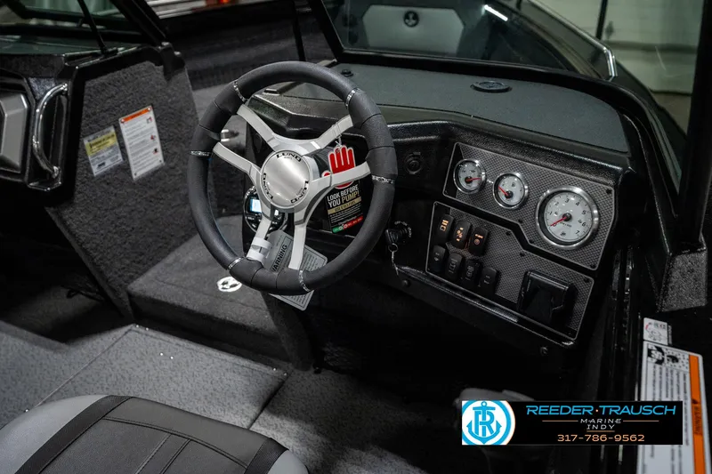 Slide: The Image of Interior of 2025 Lund 1975 Tyee boat with steering wheel and dashboard controls. - 40