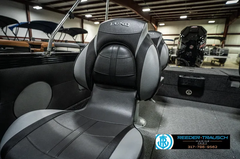 Slide: The Image of 2025 Lund 1975 Tyee boat interior with sleek black and gray seating. - 48