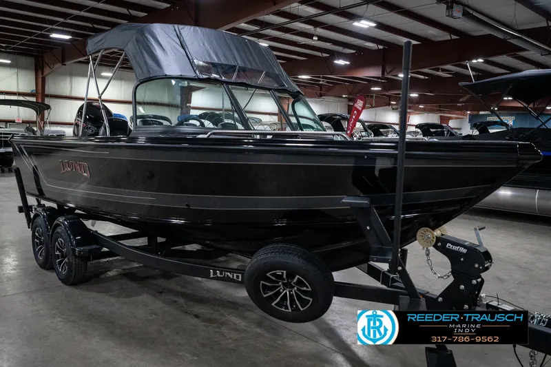 Slide: The Image of 2025 Lund 1975 Tyee boat on trailer in indoor showroom. - 5