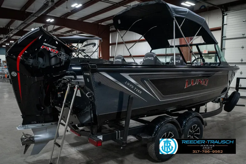 Slide: The Image of 2025 Lund 1975 Tyee boat in showroom, featuring sleek design and powerful engine. - 7