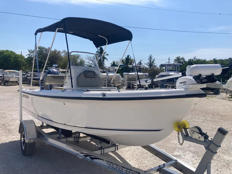 Slide: The Image of 2025 Key West 1720CC boat on trailer with canopy, parked outdoors. - 1