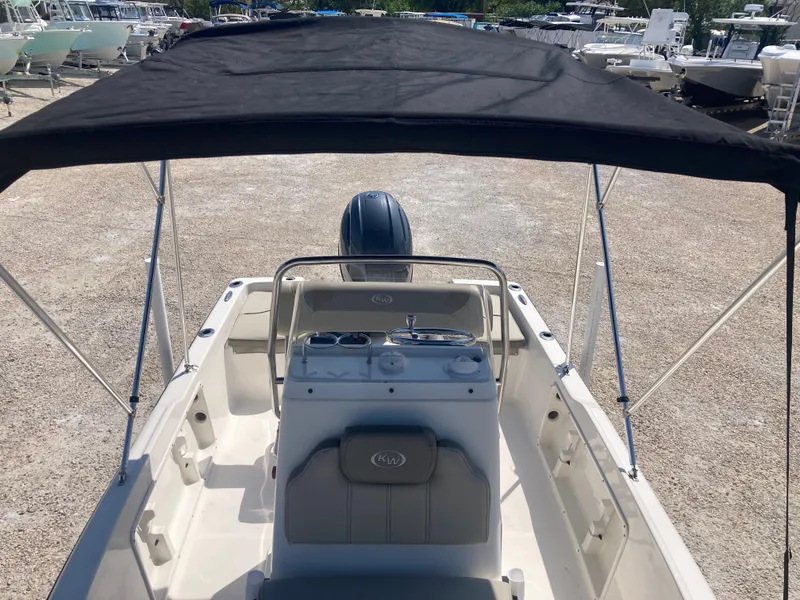 Slide: The Image of 2025 Key West 1720CC boat with canopy, parked on gravel lot. - 11