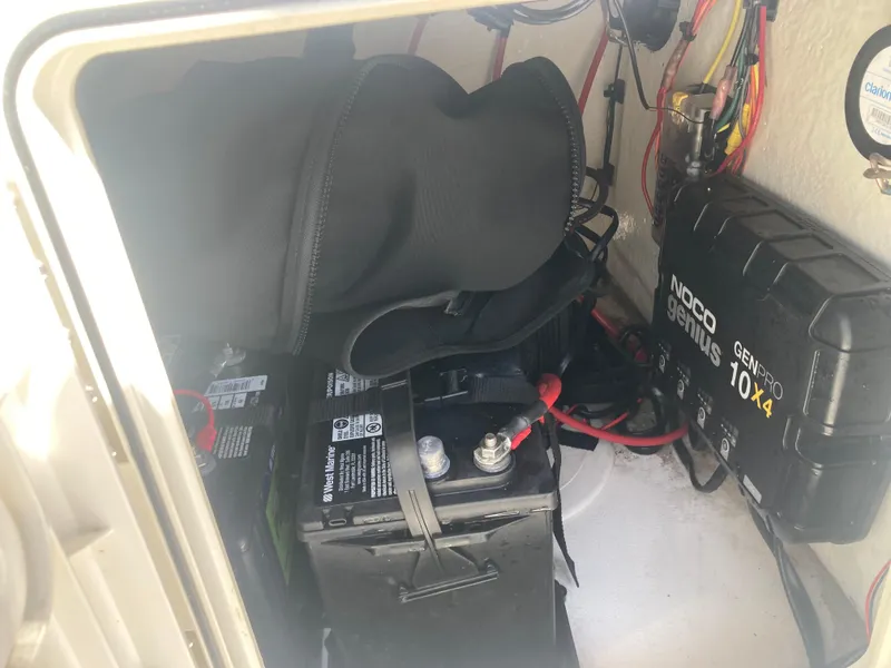 Slide: The Image of Battery compartment of 2025 Key West 1720CC boat with NOCO Genius charger. - 12