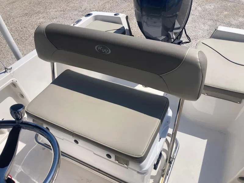 Slide: The Image of 2025 Key West 1720CC boat seat with steering wheel, featuring beige upholstery. - 13