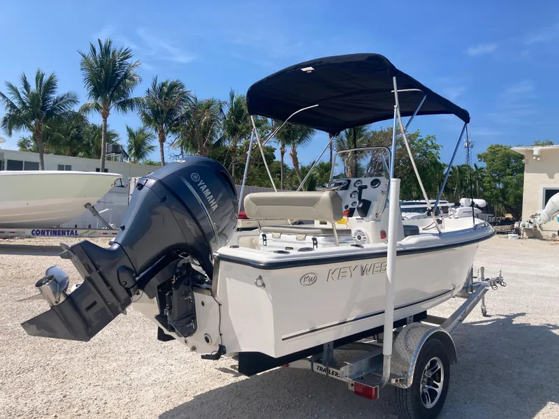 Slide: The Image of 2025 Key West 1720CC boat on trailer with Yamaha outboard, parked outdoors under clear sky. - 3