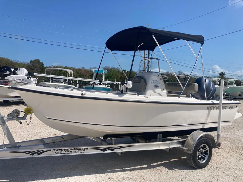 Slide: The Image of 2025 Key West 1720CC boat on trailer with canopy, parked outdoors. - 5
