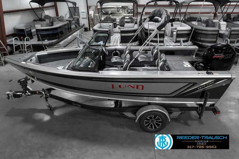 Slide: The Image of 2025 Lund 1875 Tyee boat in showroom, side view, on trailer. - 1