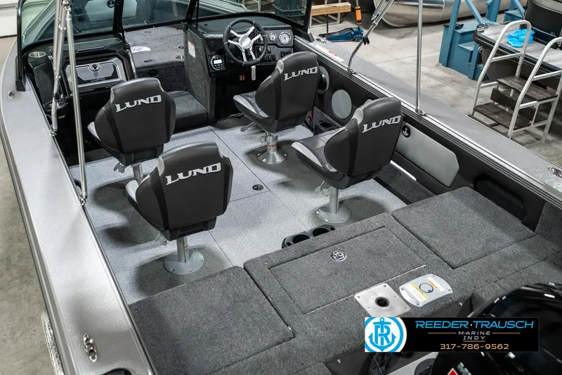 Slide: The Image of 2025 Lund 1875 Tyee boat interior with four seats and steering console. - 15