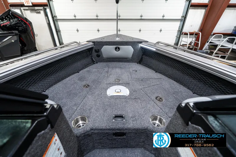 Slide: The Image of 2025 Lund 1875 Tyee boat interior with gray carpet and storage compartments. - 18