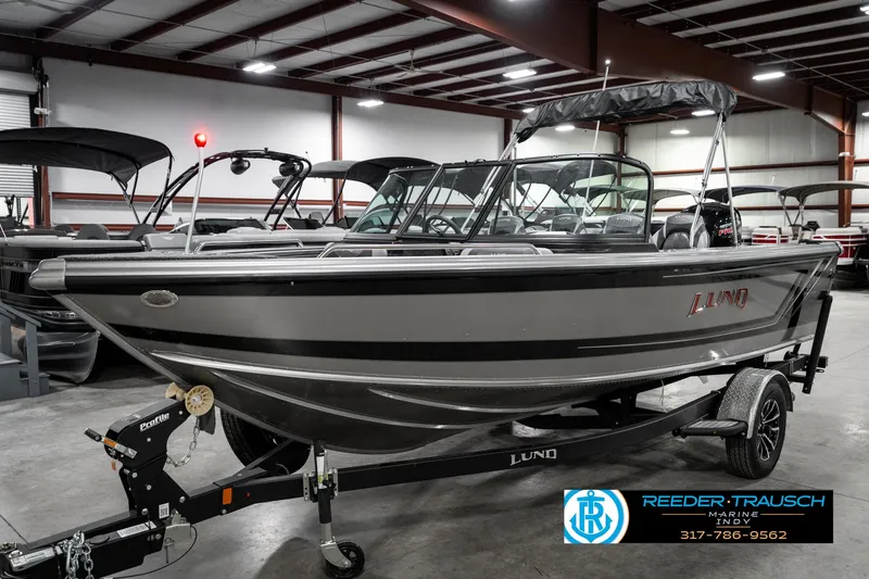 Slide: The Image of 2025 Lund 1875 Tyee boat in showroom, featuring sleek design and modern features. - 2
