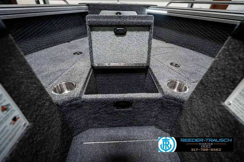 Slide: The Image of 2025 Lund 1875 Tyee boat interior with storage compartments and cup holders. - 26