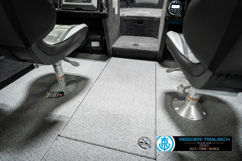 Slide: The Image of 2025 Lund 1875 Tyee boat interior with two swivel seats and carpeted flooring. - 29