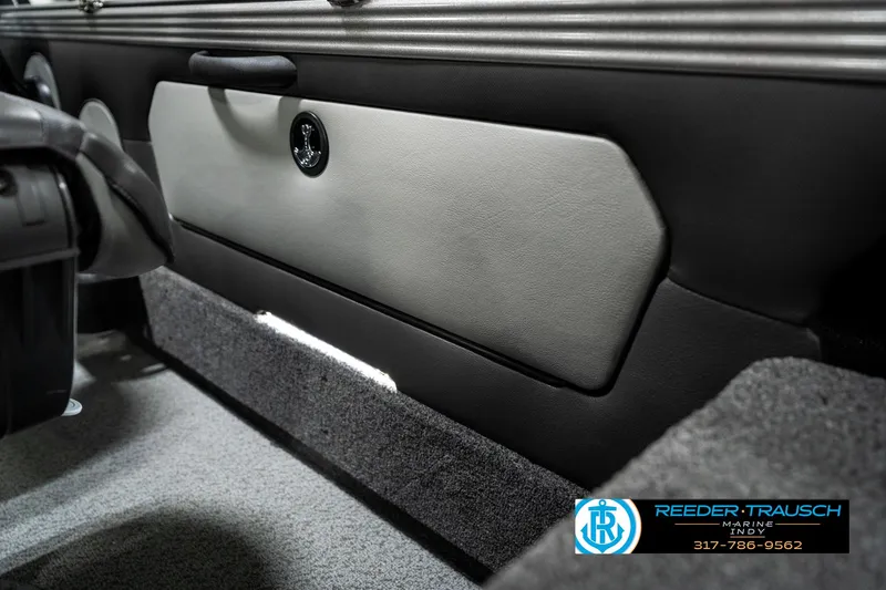 Slide: The Image of Interior view of 2025 Lund 1875 Tyee boat, featuring storage compartment and carpeted flooring. - 31
