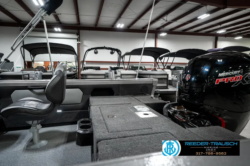 Slide: The Image of 2025 Lund 1875 Tyee boat interior with Mercury Pro XS engine in showroom. - 34