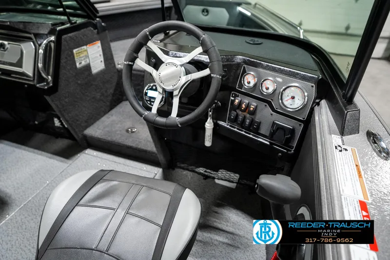 Slide: The Image of 2025 Lund 1875 Tyee boat interior with steering wheel and dashboard controls. - 37