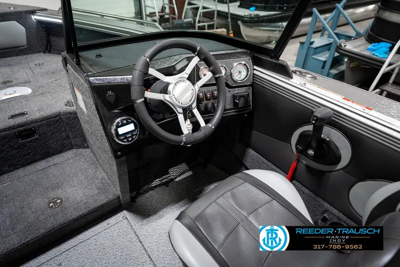Slide: The Image of 2025 Lund 1875 Tyee boat interior with steering wheel and dashboard controls. - 38