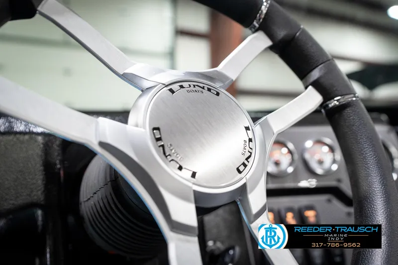 Slide: The Image of Steering wheel of 2025 Lund 1875 Tyee boat, featuring sleek design and modern controls. - 39