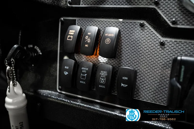 Slide: The Image of Control panel of 2025 Lund 1875 Tyee boat with various switches and buttons. - 42